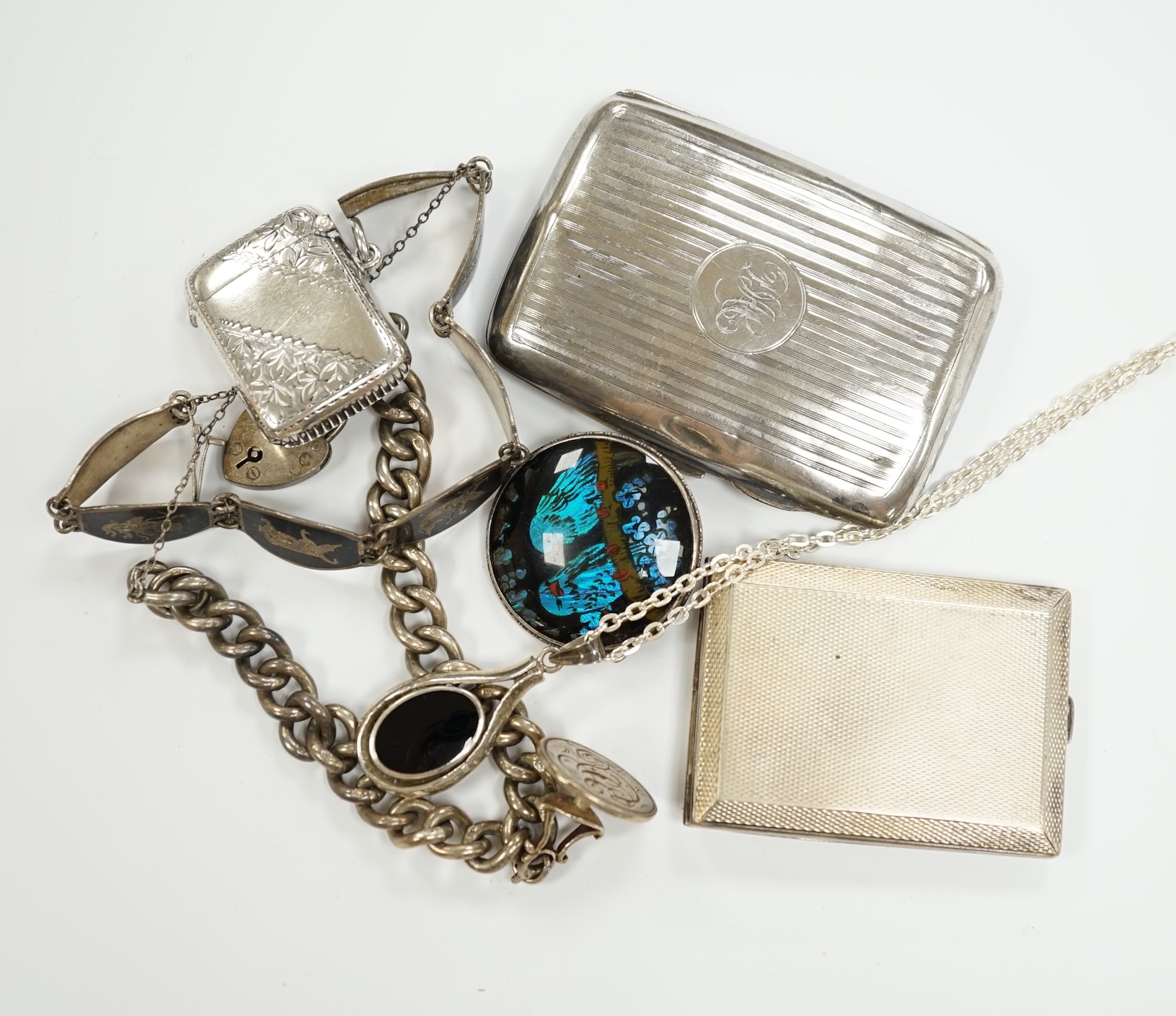 Sundry small silver including a curb link bracelet hung with Georgian seal by Charles Chesterman I, three cases including vesta and cigarette, together with three items of white metal jewellery.
